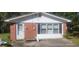 A single story brick home with a white front door and three adjacent white framed windows at 106 #2 Woodhaven Dr, Jonesboro, GA 30236