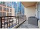City-view balcony featuring gray stone tile, metal railing, and an air conditioning unit at 1101 Juniper Ne St # 415, Atlanta, GA 30309