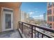 Wide balcony with a metal railing and stone floors offers fantastic city views and ample natural light at 1101 Juniper Ne St # 415, Atlanta, GA 30309
