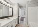Bathroom with a white vanity, quartz countertop, and a view into an adjacent bedroom at 1101 Juniper Ne St # 415, Atlanta, GA 30309