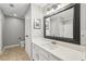 Bathroom featuring an extended vanity, a framed mirror, and a toilet at 1101 Juniper Ne St # 415, Atlanta, GA 30309