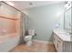 Spacious bathroom featuring a tub-shower, toilet, and vanity with a large mirror and storage at 1101 Juniper Ne St # 415, Atlanta, GA 30309