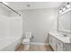 Bathroom with a shower-tub combo, white subway tile surround, toilet and white vanity at 1101 Juniper Ne St # 415, Atlanta, GA 30309