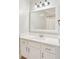 Bathroom vanity featuring white cabinets, a white quartz countertop and large mirror at 1101 Juniper Ne St # 415, Atlanta, GA 30309