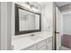 Bathroom with a white vanity, quartz countertop, and a large mirror at 1101 Juniper Ne St # 415, Atlanta, GA 30309