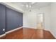 Bedroom featuring wood floors, a dark accent wall, a window and doorway to the bathroom at 1101 Juniper Ne St # 415, Atlanta, GA 30309