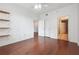 Bedroom with hardwood floors, custom wall shelving, and direct access to the bathroom at 1101 Juniper Ne St # 415, Atlanta, GA 30309