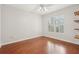 Bedroom showcasing wood floors, a ceiling fan, a window and a closet with built-in wood shelving at 1101 Juniper Ne St # 415, Atlanta, GA 30309