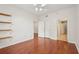 Spacious bedroom featuring wood floors, a ceiling fan, closet and doors leading to more rooms at 1101 Juniper Ne St # 415, Atlanta, GA 30309