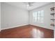 Cozy bedroom with hardwood floors, a ceiling fan, and custom wall shelving at 1101 Juniper Ne St # 415, Atlanta, GA 30309