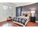 Bedroom featuring wood floors, a bed with plaid blanket, large window and patterned wall at 1101 Juniper Ne St # 415, Atlanta, GA 30309