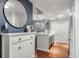 The entryway features stylish decor, including a round mirror, wood floors, and a view into the adjacent kitchen at 1101 Juniper Ne St # 415, Atlanta, GA 30309