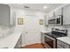 This kitchen has stainless steel appliances, gray cabinets, white countertops, and a stylish tile backsplash at 1101 Juniper Ne St # 415, Atlanta, GA 30309