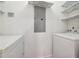 Bright laundry room with a washer, dryer, and white marble shelving for optimal storage and organization at 1101 Juniper Ne St # 415, Atlanta, GA 30309