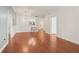 Open-concept living area with hardwood floors, white walls, and a breakfast bar with stools at 1101 Juniper Ne St # 415, Atlanta, GA 30309