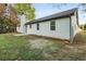 View of backyard featuring modern home exterior and a manicured lawn at 175 Cypress Dr, Covington, GA 30016
