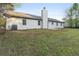 Expansive backyard featuring a well-maintained lawn, patio, and the exterior of the home with tidy siding at 175 Cypress Dr, Covington, GA 30016