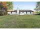 A sprawling backyard featuring a well-maintained lawn and a charming home exterior at 175 Cypress Dr, Covington, GA 30016