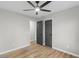 Bedroom with modern ceiling fan, light wood floors, and gray painted doors at 175 Cypress Dr, Covington, GA 30016