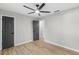A modern bedroom featuring a contemporary ceiling fan and light wood flooring at 175 Cypress Dr, Covington, GA 30016