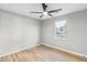 A bright bedroom featuring a modern ceiling fan and a view from the window at 175 Cypress Dr, Covington, GA 30016
