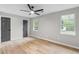 Spacious bedroom with two windows, a ceiling fan and light wood floors at 175 Cypress Dr, Covington, GA 30016