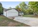 Exterior showing the long driveway that leads up to this vinyl-sided one-story home and attached garage at 175 Cypress Dr, Covington, GA 30016