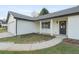The front of this one-story home featuring a covered porch and well-manicured lawn at 175 Cypress Dr, Covington, GA 30016