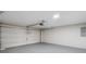 A garage area featuring a white garage door, modern lighting, and light gray painted floor at 175 Cypress Dr, Covington, GA 30016