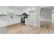 A spacious kitchen with white cabinets, stainless steel appliances, and wood flooring at 175 Cypress Dr, Covington, GA 30016