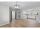 Modern kitchen with white cabinetry, stainless steel appliances, and wood flooring adjacent to the dining area at 175 Cypress Dr, Covington, GA 30016