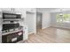 View of kitchen with stainless steel appliances next to a dining area with light wood floors at 175 Cypress Dr, Covington, GA 30016