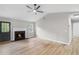 Spacious living room with wood flooring, a ceiling fan, a fireplace and abundant natural light at 175 Cypress Dr, Covington, GA 30016