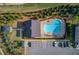 Aerial view of a community pool with plenty of parking, a pool house and manicured lawns at 2042 Clay Rd, Snellville, GA 30078