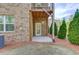 Cozy back patio with brick exterior, covered deck, and access door to the home's interior at 2042 Clay Rd, Snellville, GA 30078