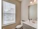 Bathroom featuring a window, toilet and vanity with a gray cabinet at 2042 Clay Rd, Snellville, GA 30078