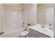 Bright bathroom with a white tub and shower combo, toilet, sink and vanity offering ample counter space at 2042 Clay Rd, Snellville, GA 30078