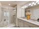 Bathroom featuring a double vanity, granite countertops and glass enclosed shower at 2042 Clay Rd, Snellville, GA 30078