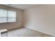 Empty carpeted bedroom featuring natural light, and neutral walls creating a warm and inviting atmosphere at 2042 Clay Rd, Snellville, GA 30078