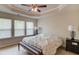 Bedroom featuring natural light, carpet, ceiling fan, tray ceiling, and bench at the end of the bed at 2042 Clay Rd, Snellville, GA 30078