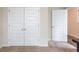 Bedroom featuring double closet doors in white, and an open single door, offering ample storage space at 2042 Clay Rd, Snellville, GA 30078