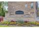 A welcoming community entrance with a stone sign and colorful floral landscaping at 2042 Clay Rd, Snellville, GA 30078