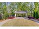 Exterior shot of a shaded community gazebo surrounded by lush trees and manicured landscaping at 2042 Clay Rd, Snellville, GA 30078