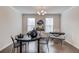 A dining room area featuring a round table with chairs, chandelier, hardwood floors, and natural light from the window at 2042 Clay Rd, Snellville, GA 30078
