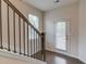 Hallway with staircase featuring dark wood handrail and a glass door for plenty of natural light at 2042 Clay Rd, Snellville, GA 30078