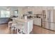 Bright kitchen featuring an island with granite countertops, stainless steel appliances, hardwood floors, and recessed lighting at 2042 Clay Rd, Snellville, GA 30078