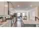 Open kitchen featuring an island with granite countertops, stainless steel appliances, hardwood floors, and recessed lighting at 2042 Clay Rd, Snellville, GA 30078