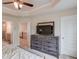 This main bedroom has a decorative ceiling, ceiling fan and a rustic wood dresser at 2042 Clay Rd, Snellville, GA 30078