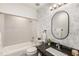 Bright bathroom features tub, vanity, black granite countertop, decorative mirror, and patterned wallpaper at 3228 Clairmont North Ne # 3228-A, Brookhaven, GA 30329