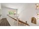 Second floor hallway with wood floors, and a view into the living room below at 3228 Clairmont North Ne # 3228-A, Brookhaven, GA 30329